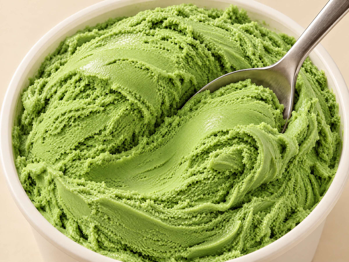 Close-up of Lime Blast gelato in a tub with a spoon