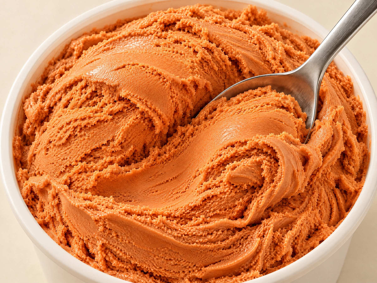 Close-up of Blood Orange Punch gelato in a tub with a spoon