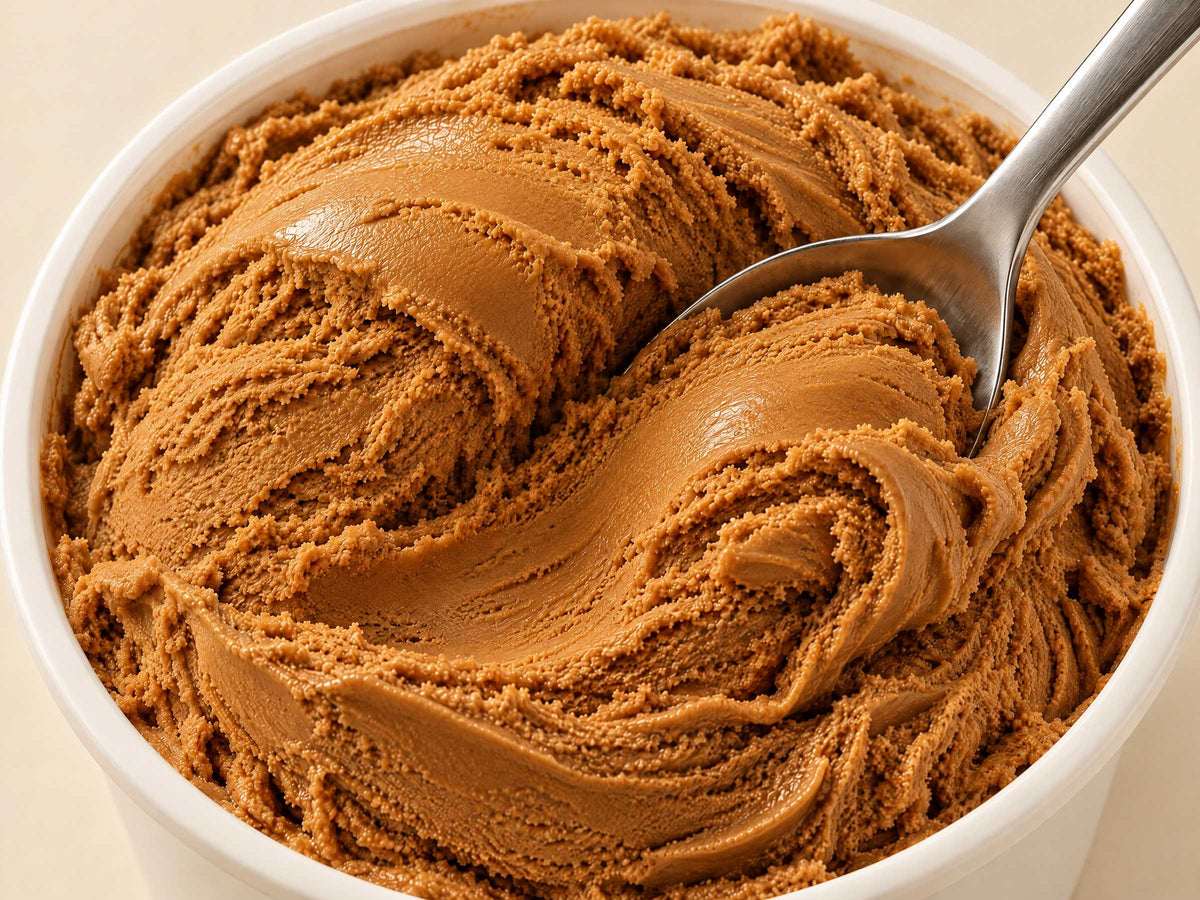 Close-up of Salty Caramel gelato in a tub with a spoon