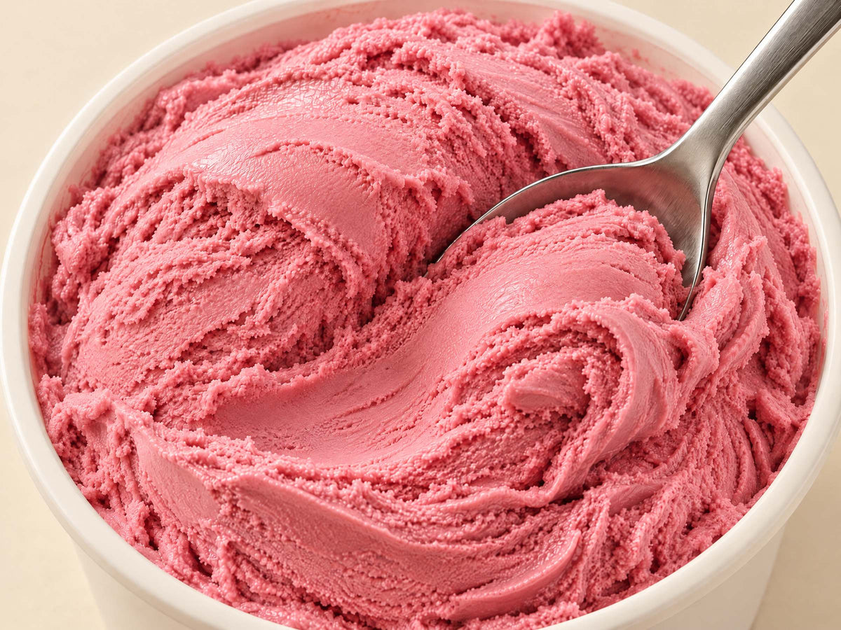 Close-up of Strawberry Rush gelato in a tub with a spoon