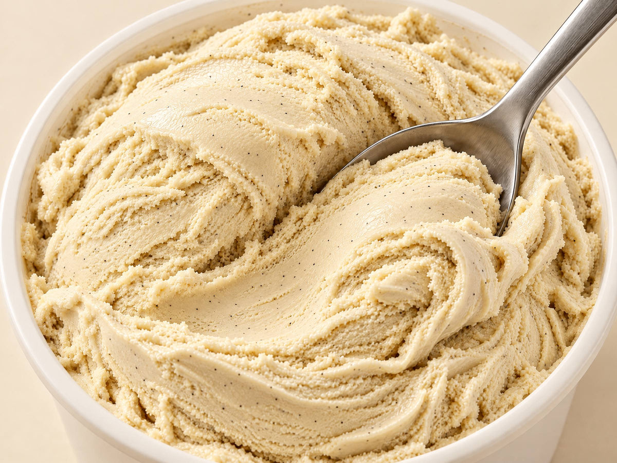 Close-up of Vanilla Bean gelato in a tub with a spoon